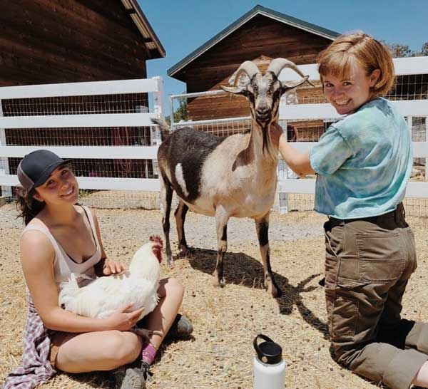 Rancho Compasion Sanctuary Teens at barn with goat