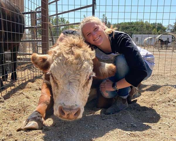 Student with cow at Jameson Humane Sanctuary