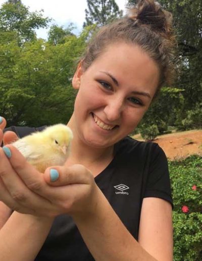 young woman holding baby chick