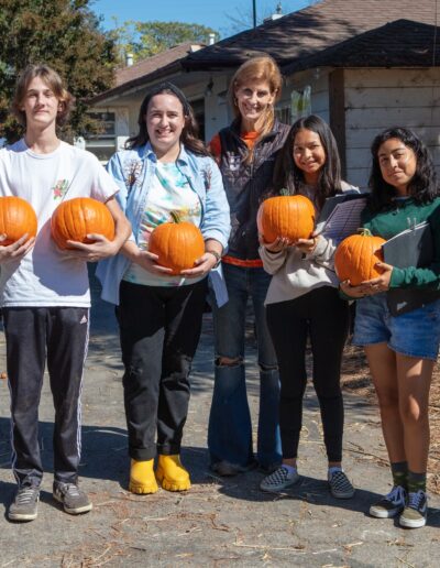 LEAP students with pumpkins for the pigs.